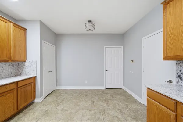 a spacious bathroom with a granite countertop sink and a mirror