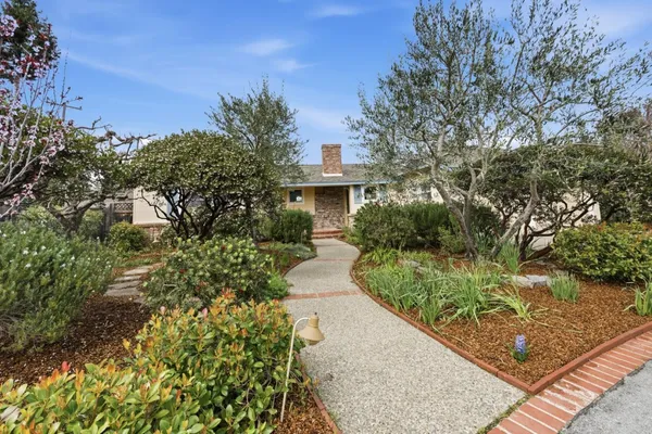 a front view of a house with garden