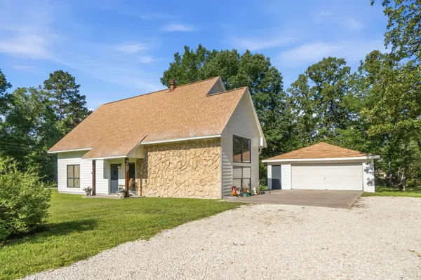 a view of front a house with a yard and garage