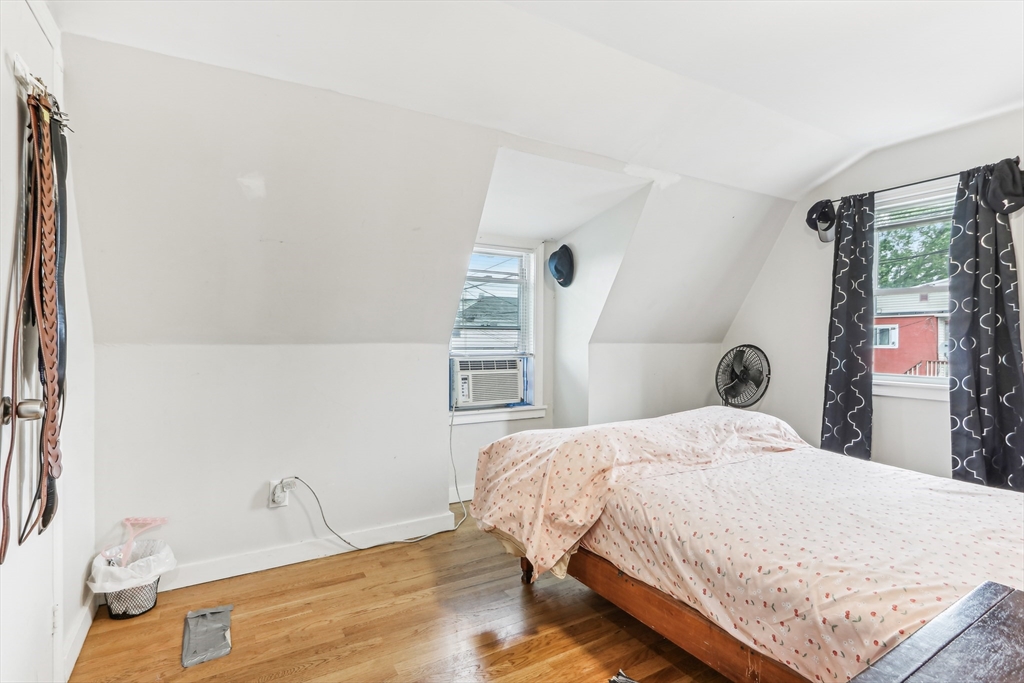 831 North Shore Road Revere, MA 02151 - Photo 20 of 24 a bedroom with a bed and wooden floor