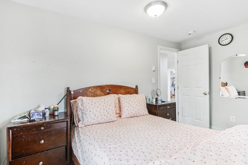 831 North Shore Road Revere, MA 02151 - Photo 21 of 24 a bedroom with a bed and a dresser