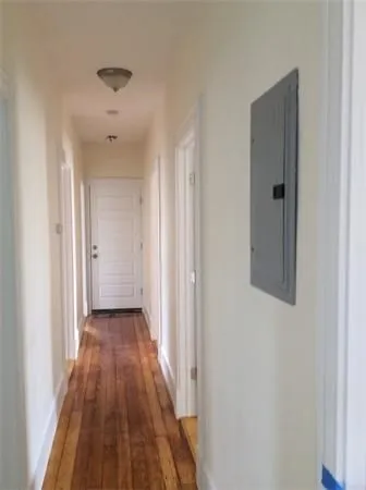 a view of a hallway with wooden floor