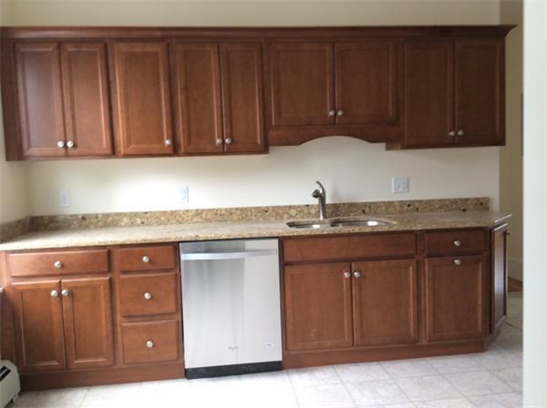 15 Romsey Street, Unit 3 Boston, MA 02125 - Photo 2 of 14 a kitchen with granite countertop cabinets and window