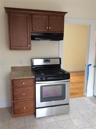 15 Romsey Street, Unit 3 Boston, MA 02125 - Photo 3 of 14 a stove top oven sitting inside of a kitchen