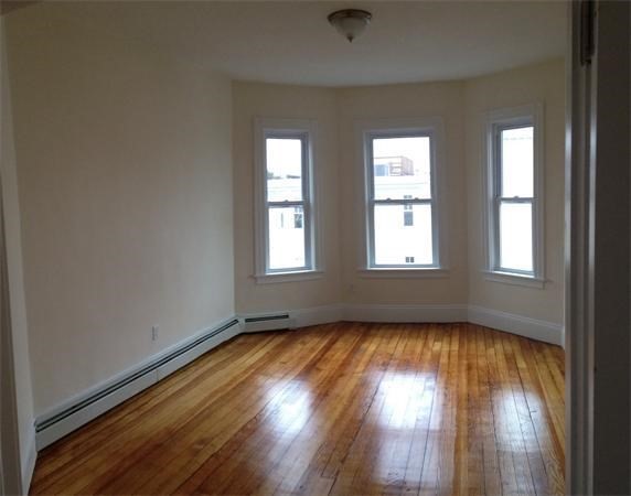 15 Romsey Street, Unit 3 Boston, MA 02125 - Photo 8 of 14 an empty room with wooden floor and windows