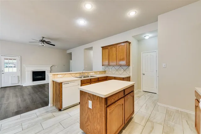 a kitchen that has a sink and a stove in it