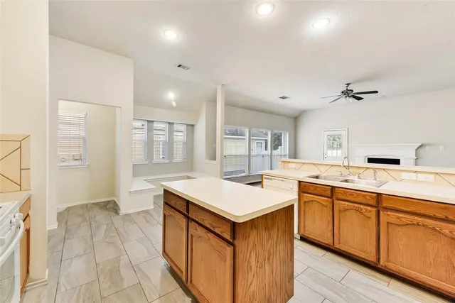 a large kitchen with a sink and cabinets