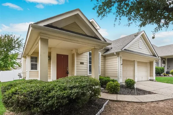 front view of a house with potted plants