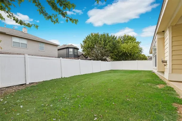 a view of a house with a backyard