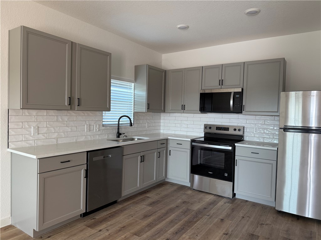 2105 Vista Rosa Three Rivers, TX 78071 - Photo 2 of 10 a kitchen with a sink cabinets stainless steel appliances and a window