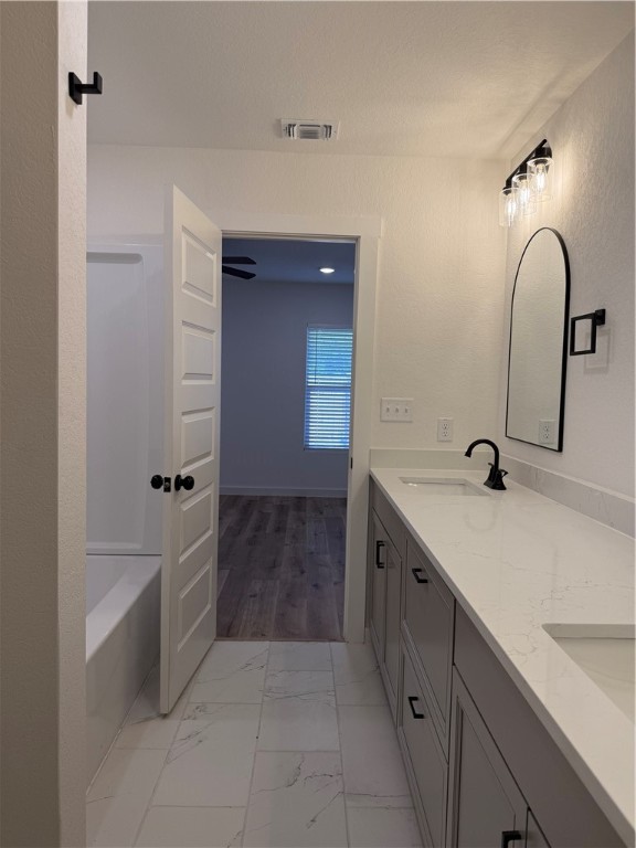 2105 Vista Rosa Three Rivers, TX 78071 - Photo 5 of 10 a bathroom with a double vanity sink and a bathtub