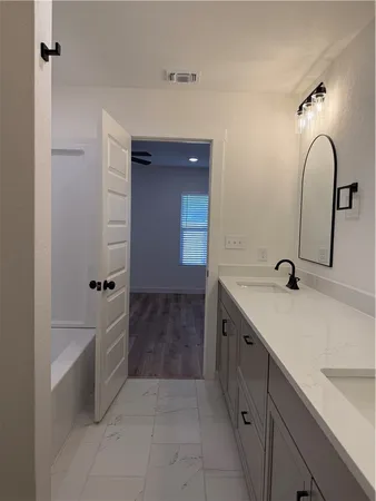 a bathroom with a double vanity sink and mirror