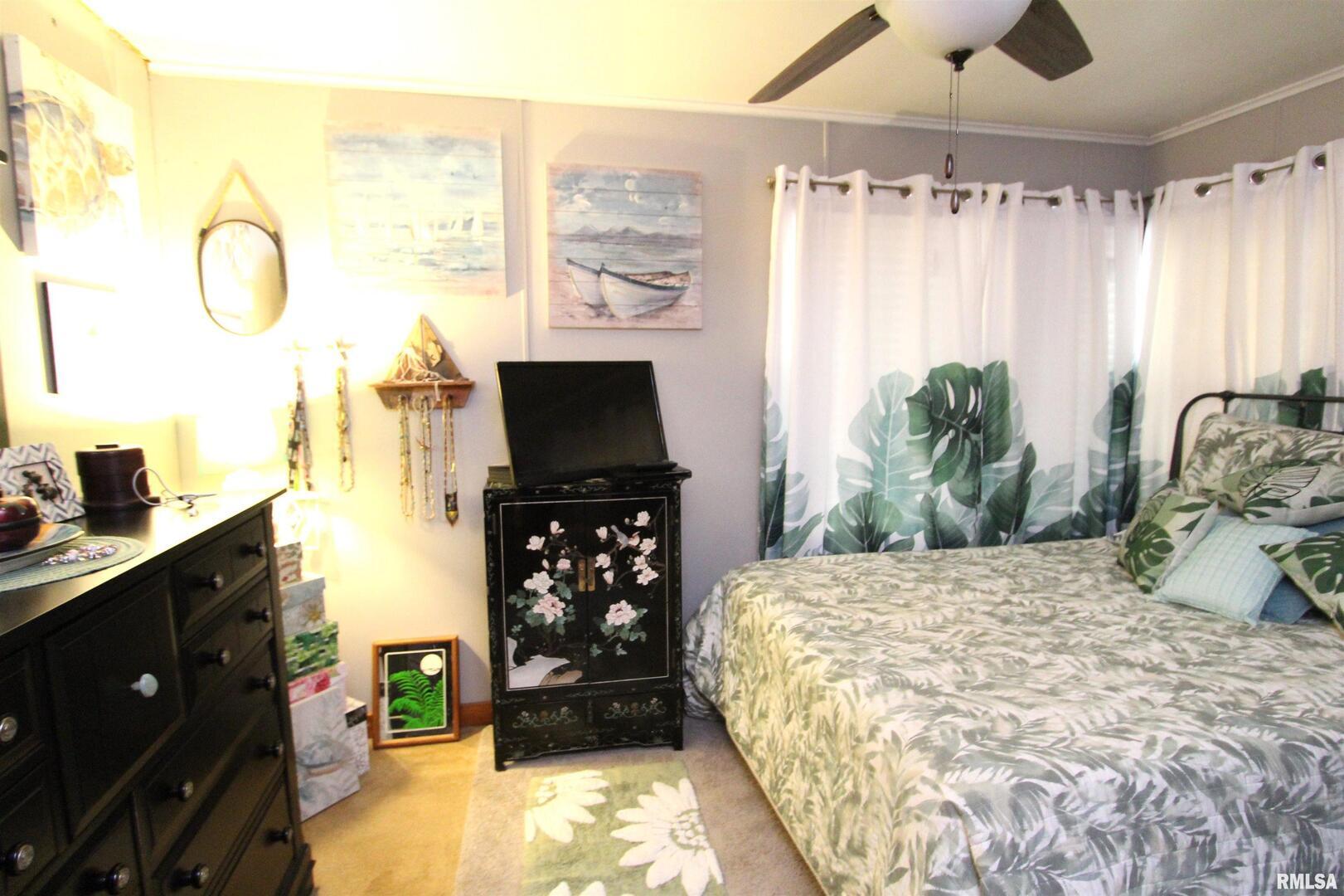 1330 Florence Avenue Clinton, IA 52732 - Photo 16 of 20 a bedroom with a bed and a flat tv screen on dresser