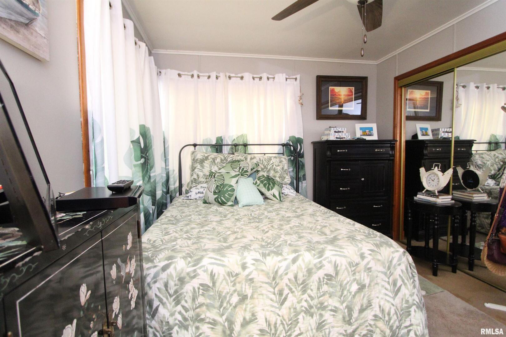 1330 Florence Avenue Clinton, IA 52732 - Photo 17 of 20 a bedroom with a bed and wooden floor