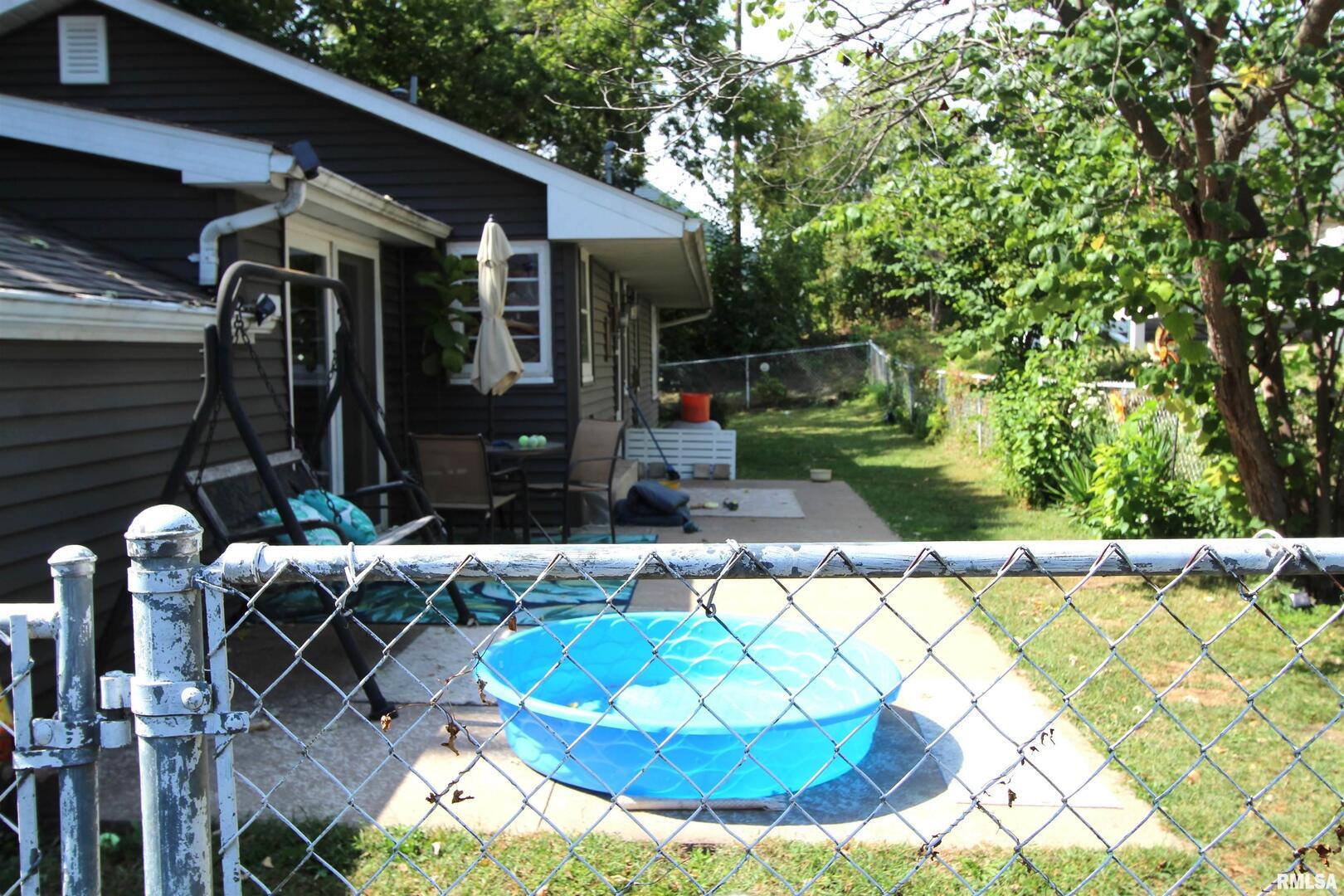 1330 Florence Avenue Clinton, IA 52732 - Photo 19 of 20 a view of a patio with table and chairs potted plants and large tree