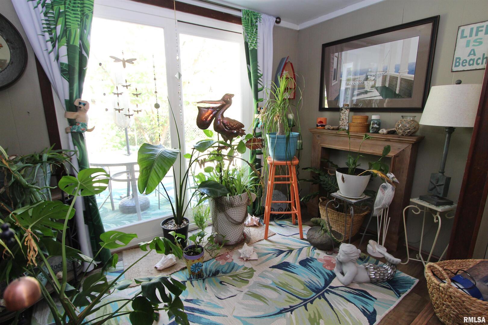 1330 Florence Avenue Clinton, IA 52732 - Photo 7 of 20 a living room with furniture a potted plant and a large window