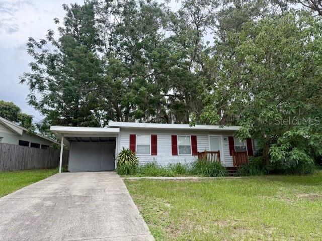 31538 Anderson Drive Tavares, FL 32778 - Photo 1 of 8 a view of a house with a yard and large tree