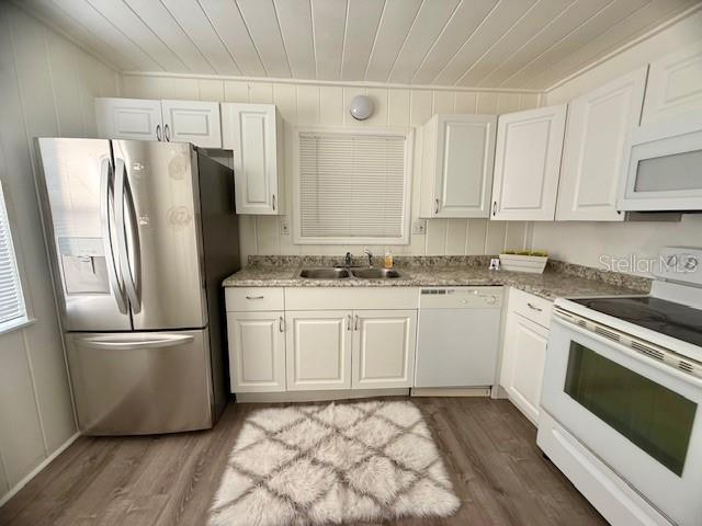 31538 Anderson Drive Tavares, FL 32778 - Photo 3 of 8 a kitchen with stainless steel appliances a refrigerator sink and microwave