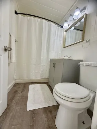 a white toilet sitting next to a shower curtain