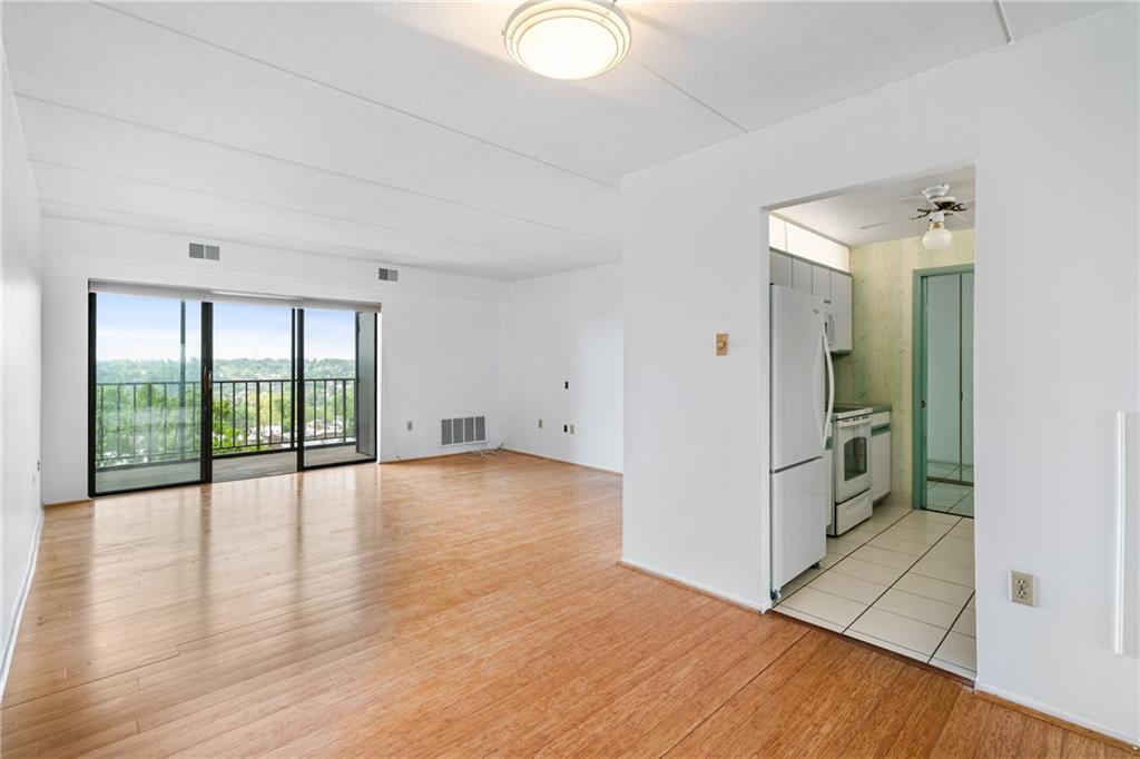 5600 Munhall Road, Unit 606 Pittsburgh, PA 15217 - Photo 8 of 19 wooden floor in an empty room with a window