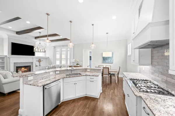 a kitchen with a stove sink and cabinets
