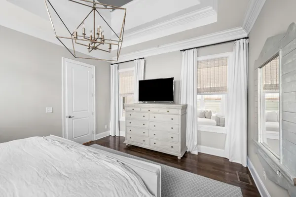 a bedroom with a bed and flat screen tv