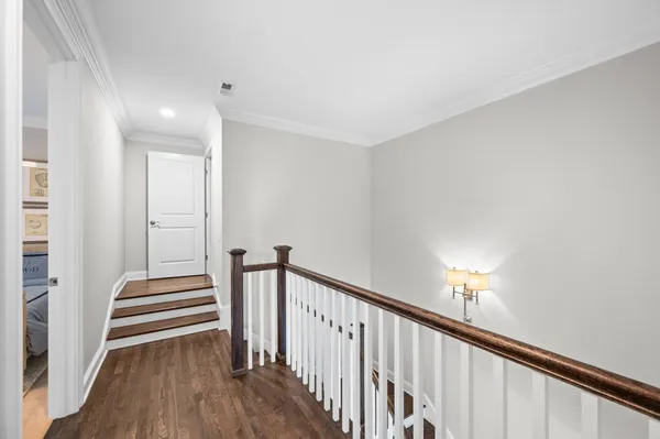 a view of entryway and hall with wooden floor