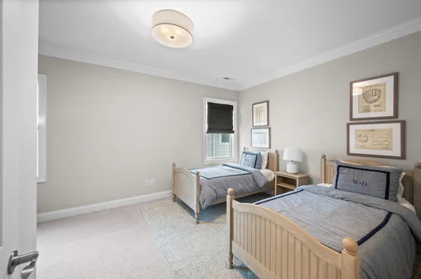 a bedroom with two beds and a closet