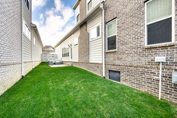 a view of house with backyard and a garden