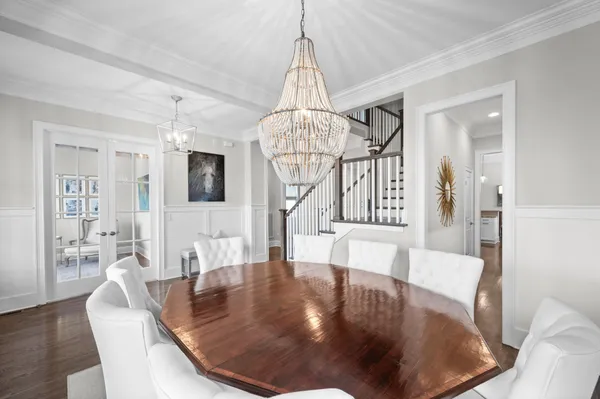 a view of a dining room with furniture wooden floor and chandelier
