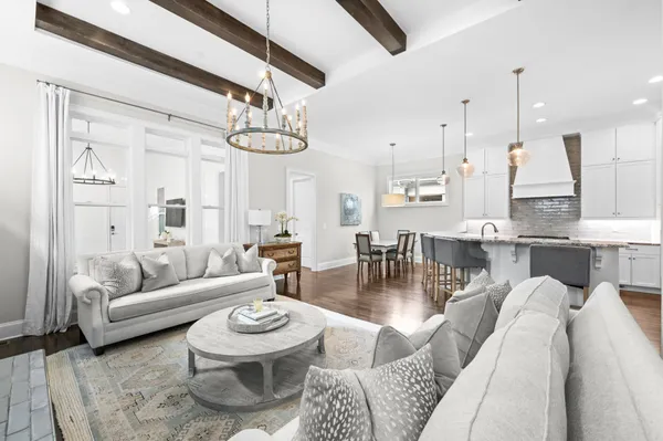 a living room with furniture and a chandelier