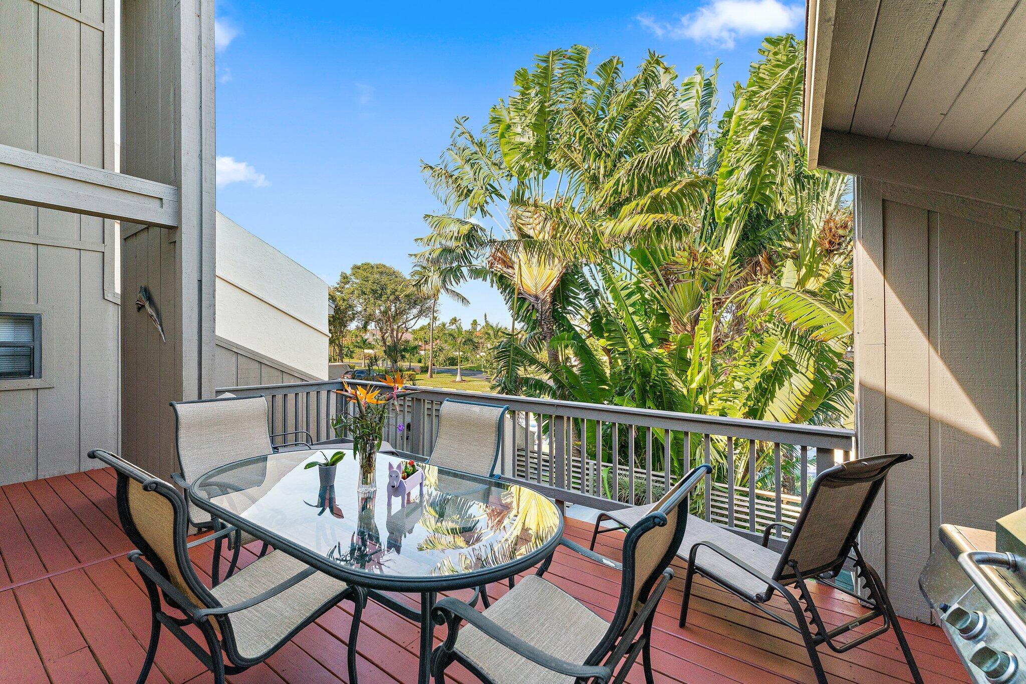 a view of a chairs and table in the balcony