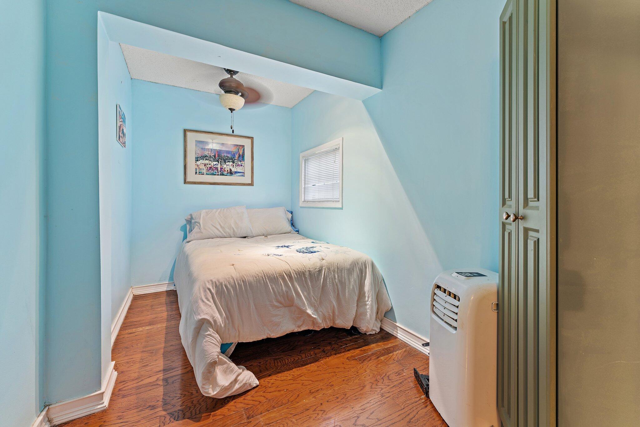 1605 Highway 1, Unit SL 5F Jupiter, FL 33477 - Photo 25 of 35 a bedroom with a bed and a painting on the wall