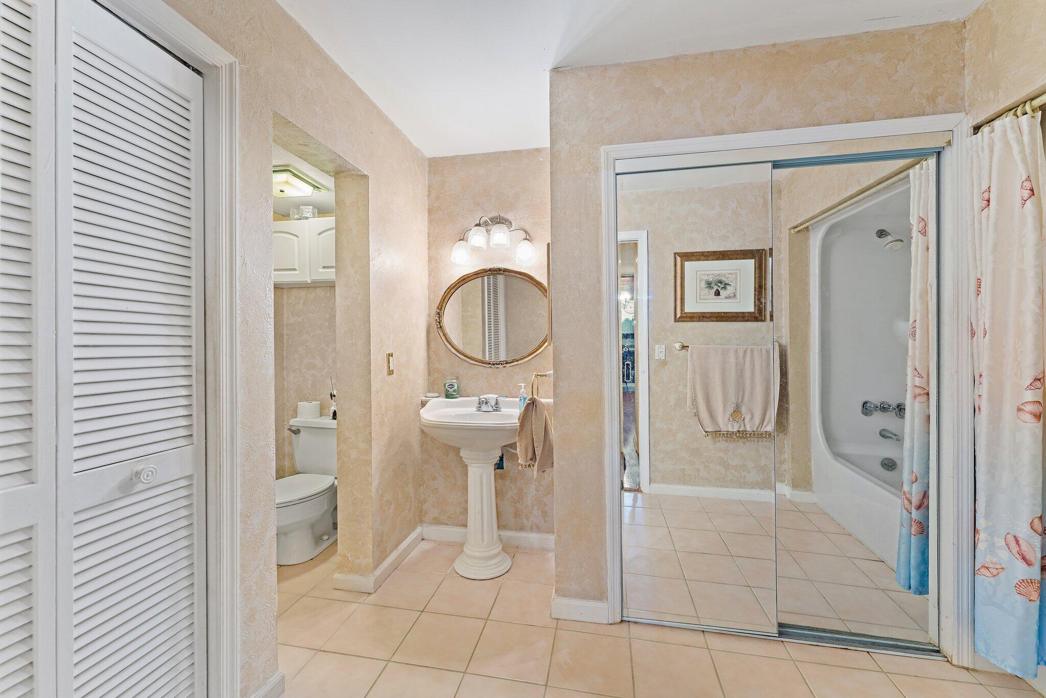 1605 Highway 1, Unit SL 5F Jupiter, FL 33477 - Photo 27 of 35 a bathroom with a toilet a sink and shower