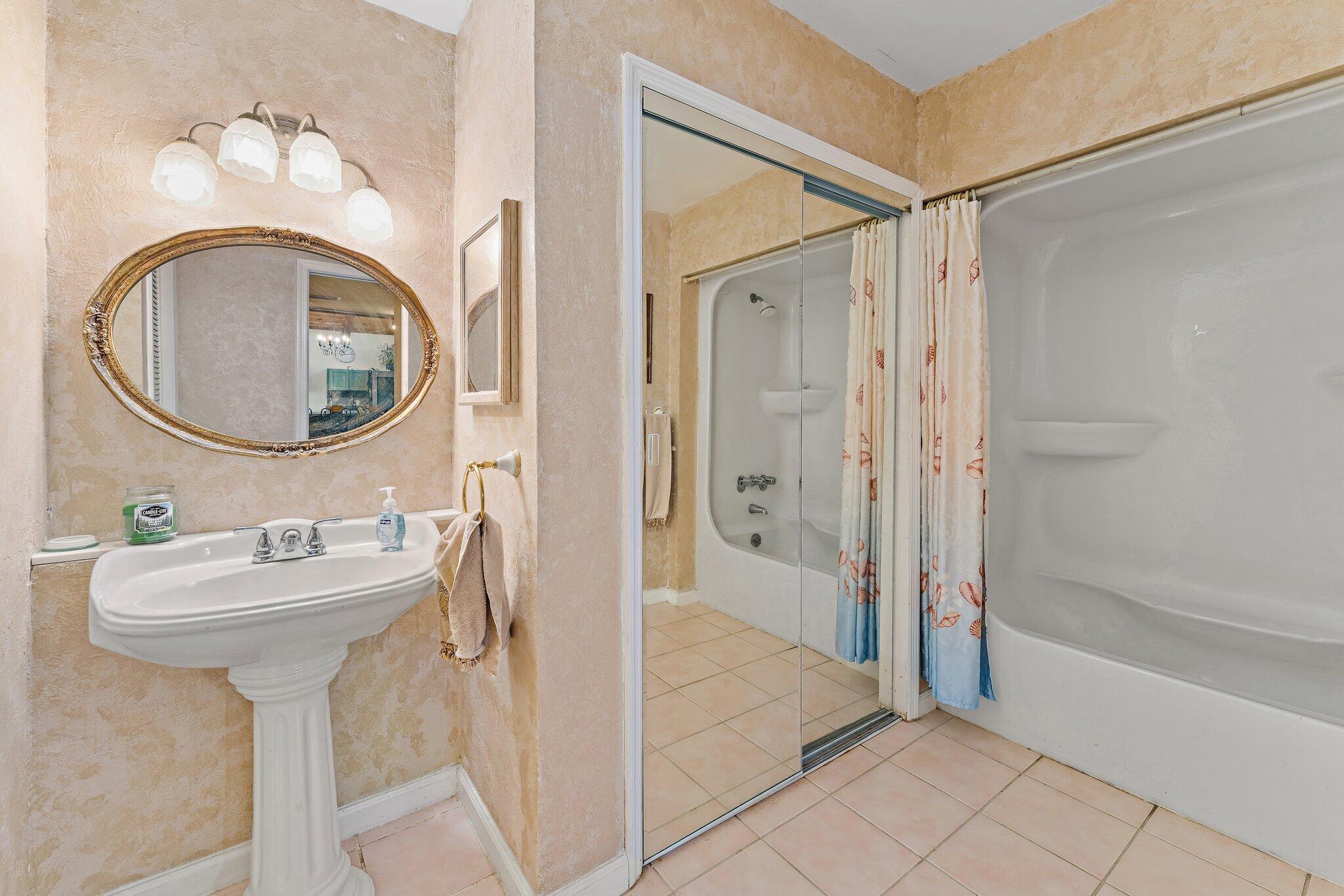 1605 Highway 1, Unit SL 5F Jupiter, FL 33477 - Photo 28 of 35 a bathroom with a sink and a mirror