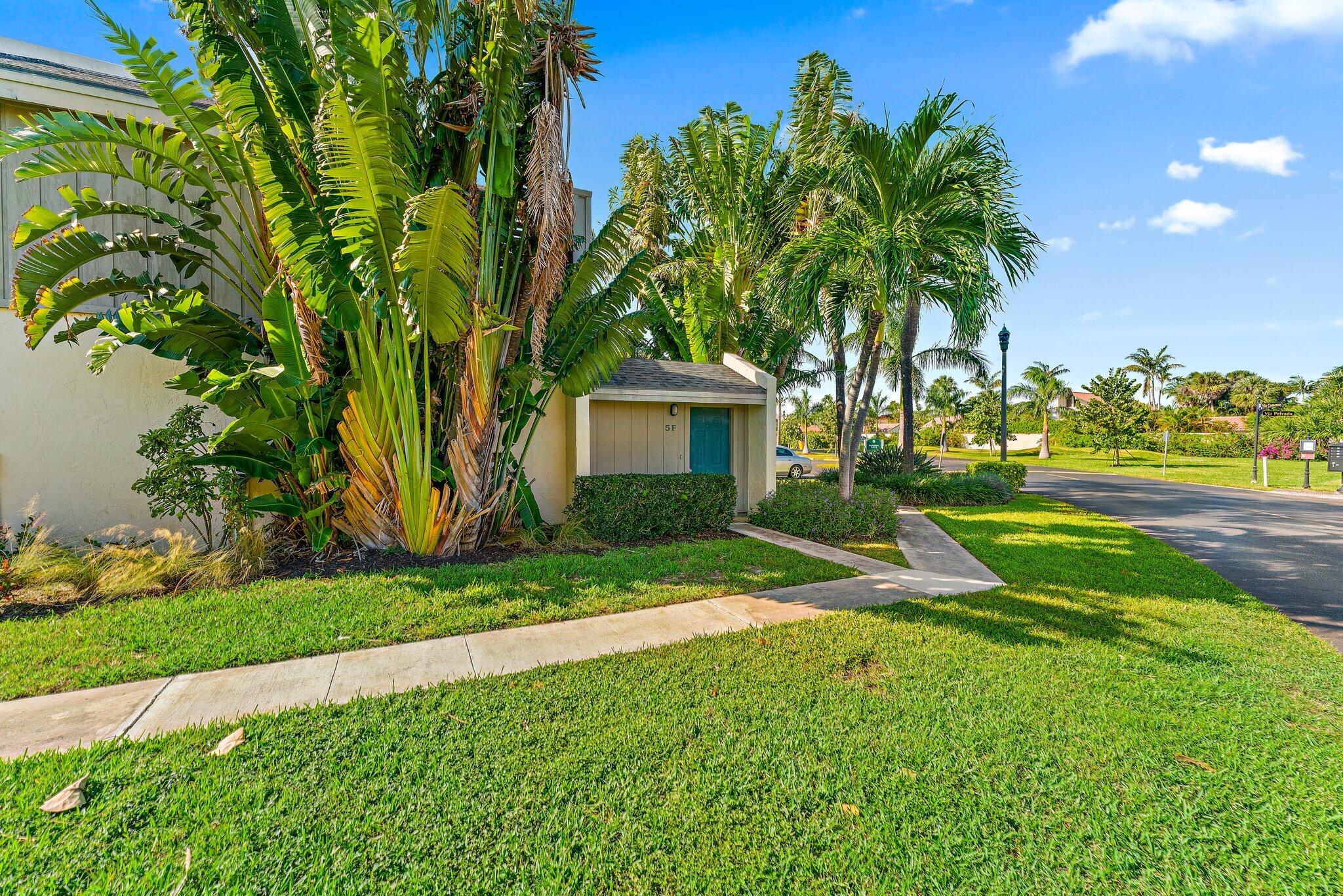 1605 Highway 1, Unit SL 5F Jupiter, FL 33477 - Photo 5 of 35 a view of a house with a tree and a yard