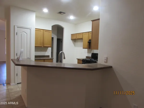 a kitchen with stainless steel appliances a sink and a refrigerator