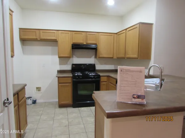 a kitchen with a sink and a stove top oven