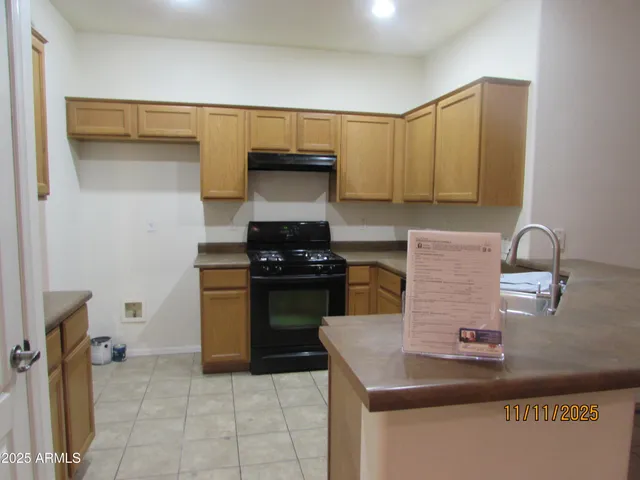a kitchen with a sink and a stove top oven