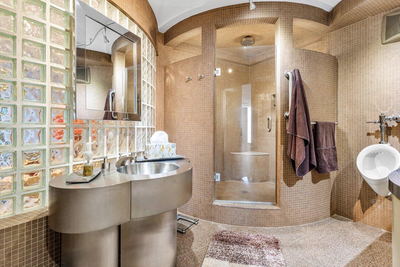 1500 South Ocean Boulevard, Unit 303/304 Boca Raton, FL 33432 - Photo 13 of 49 a bathroom with a sink and a mirror