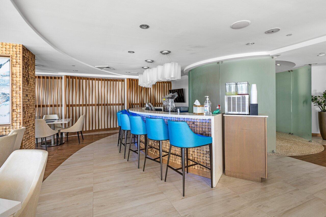 1500 South Ocean Boulevard, Unit 303/304 Boca Raton, FL 33432 - Photo 30 of 49 a room with stainless steel appliances kitchen island granite countertop furniture and a dining table