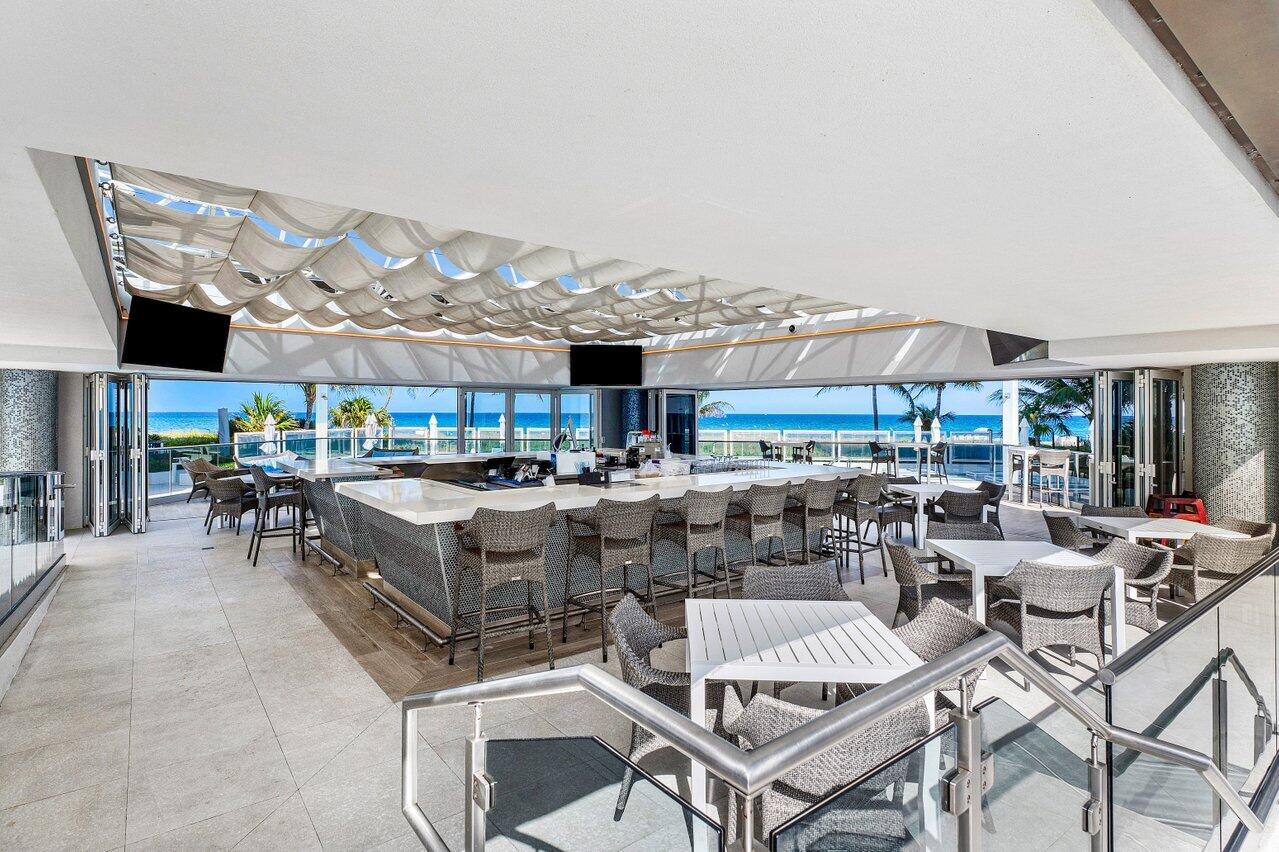 1500 South Ocean Boulevard, Unit 303/304 Boca Raton, FL 33432 - Photo 34 of 49 a view of a patio with dining table and chairs