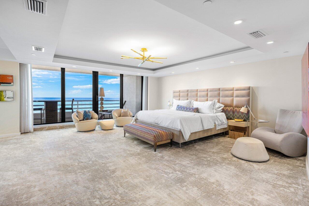 1500 South Ocean Boulevard, Unit 303/304 Boca Raton, FL 33432 - Photo 9 of 49 a spacious bedroom with a bed and large windows