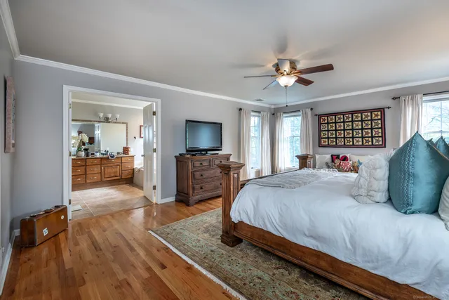 a bedroom with a bed and a chandelier