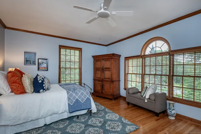 a bedroom with a bed and a large window