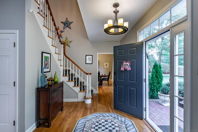 a view of entryway livingroom and hall with wooden floor