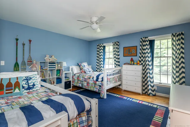 a bedroom with two beds and a large window