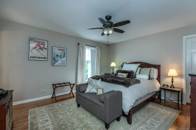 a bedroom with a bed and a chandelier