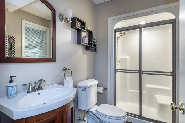 a bathroom with a sink toilet and shower