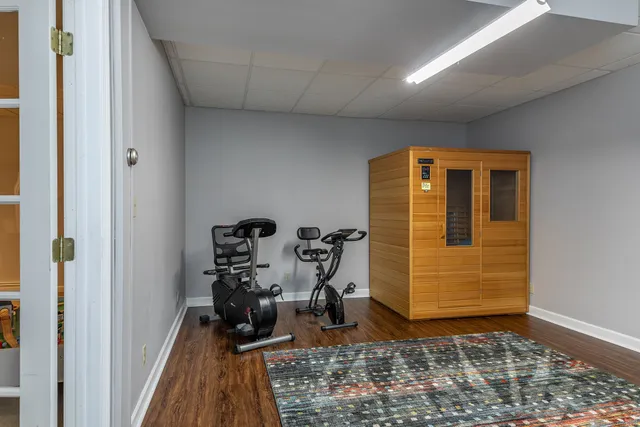 a view of a hallway with wooden floor and a closet